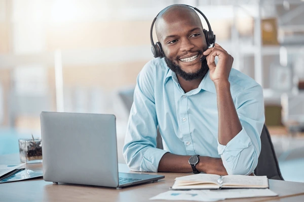 black-man-headset-consultant-office-600nw-2453759493